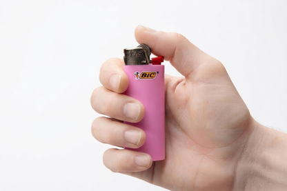 Compact pocket lighter held in hand, showing its perfect portable size
